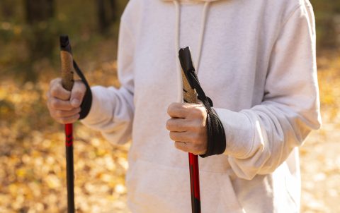 older-woman-outdoors-with-trekking-sticks